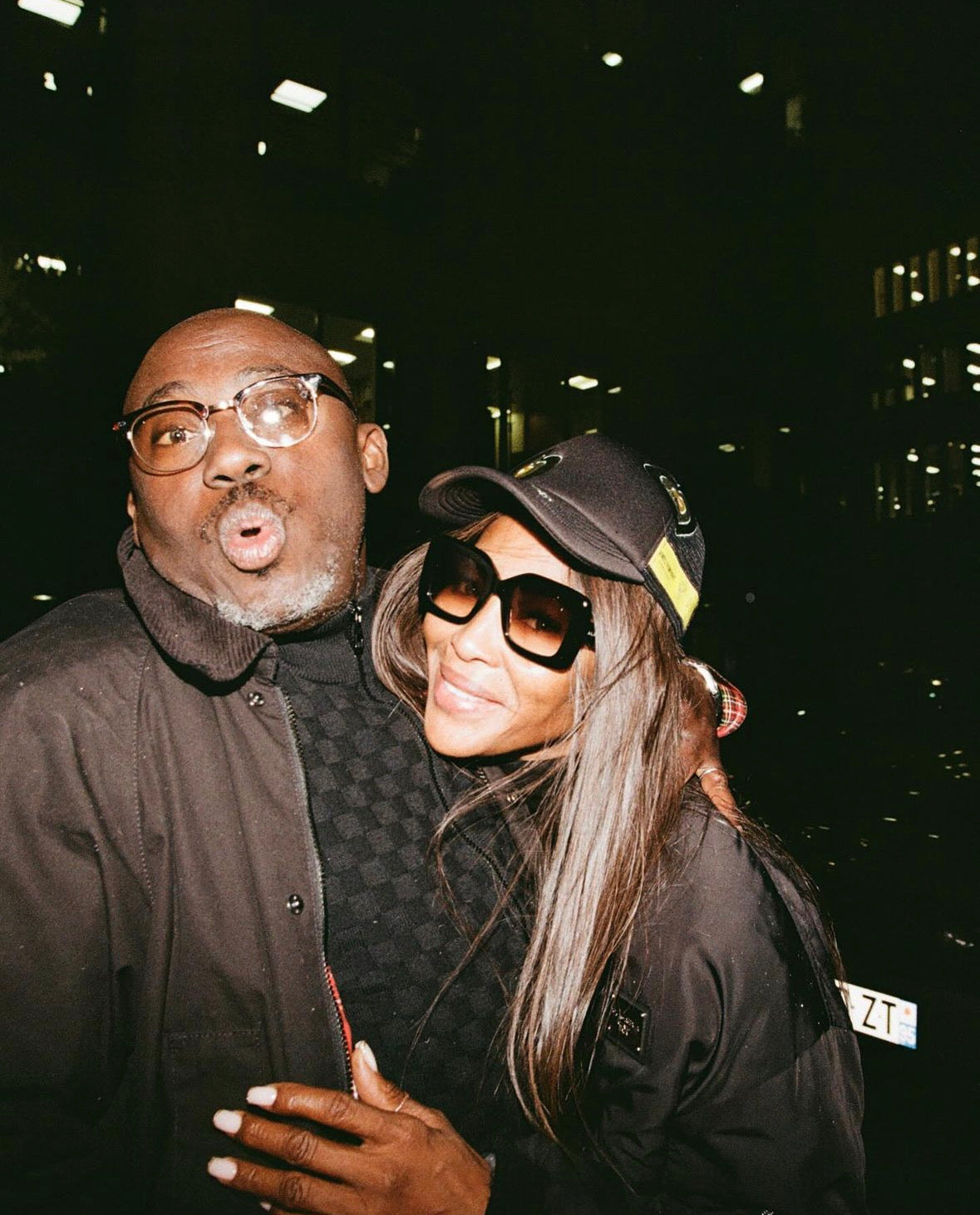 Naomi Campbell wearing HOMIES FROM PARIS Heart hat brown in company of Edward Enninful.